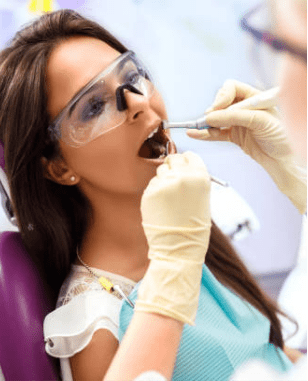 Woman in chair receiving general dentistry services in Boulder