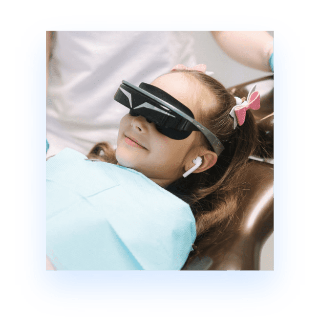 young girl in dentist chair with safety glasses