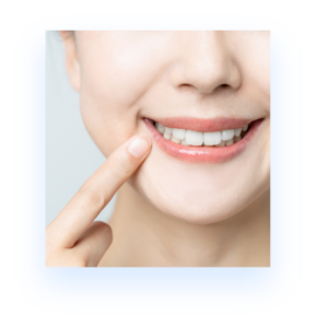 woman's lower part of face - hand pointing at smile