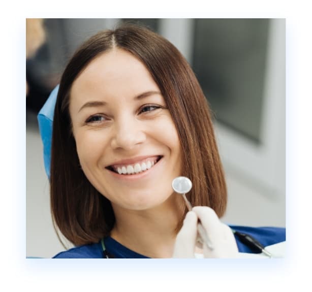 Happy young woman in dental chair